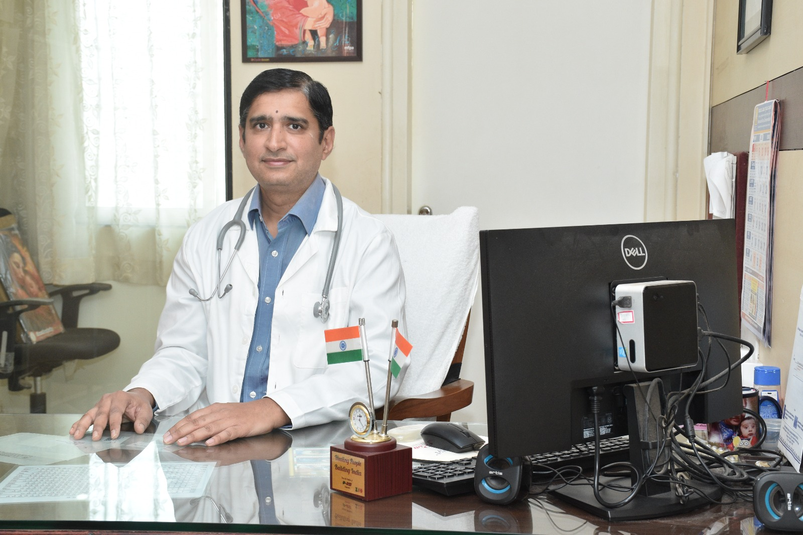 Dr. Santosh Kulkarni sitting in his clinic office